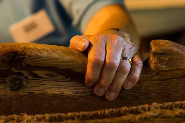 A close-up shot of a skilled woodworker carefully carving a piece of wood with traditional tools in a rustic workshop setting. Natural light streams in, highlighting the details of the wood and the craftsman's focused expression.