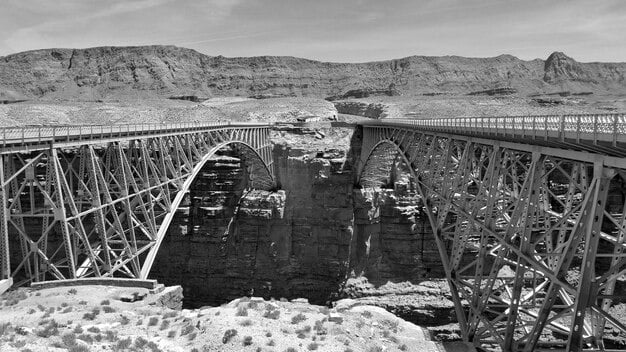 An old photograph of the construction of the Hoover Dam, highlighting the historical significance of large-scale infrastructure projects in the US.