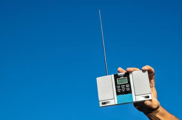 A hand holding a weather radio during a storm, emphasizing the importance of staying informed with the latest weather updates and emergency broadcasts.